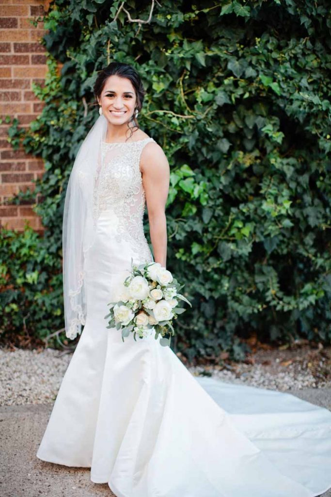 Bridal portraits at Legacy Event Center in Lubbock Texas. Bride in glamours trumpet gown with white bouquet. Texas wedding florist Jessica Ormond Events. Lubbock photographer Tara Hobgood Photography.